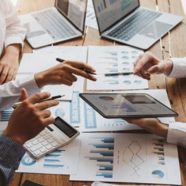 Accounting team, Cropped shot of diverse coworkers working together in the boardroom, brainstorming, discussing, and analyzing business strategy.